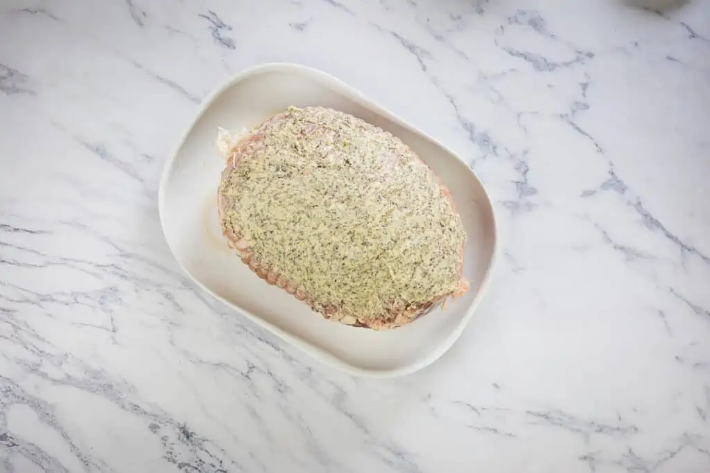 Turkey roll roast covered with herbed butter.