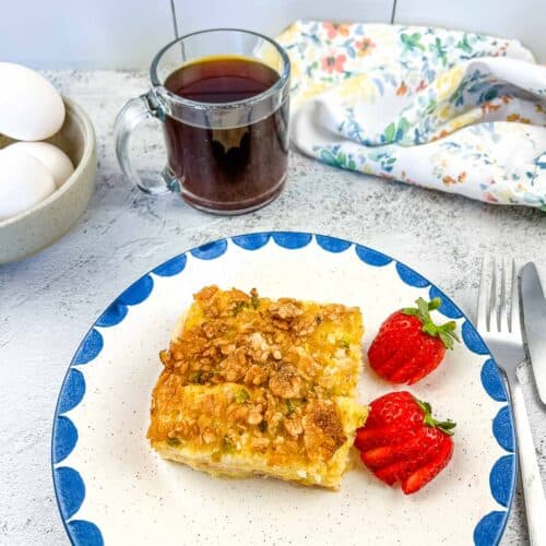 Christmas Morning Casserole on a plate with strawberries.