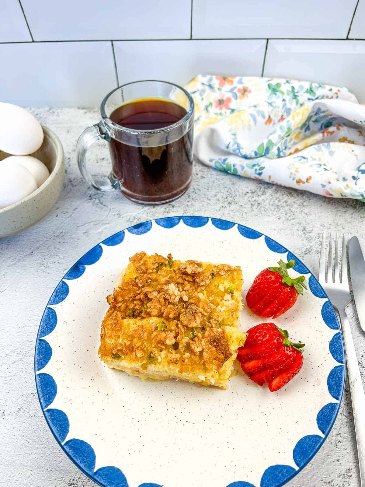 Christmas Morning Casserole on a plate with strawberries.