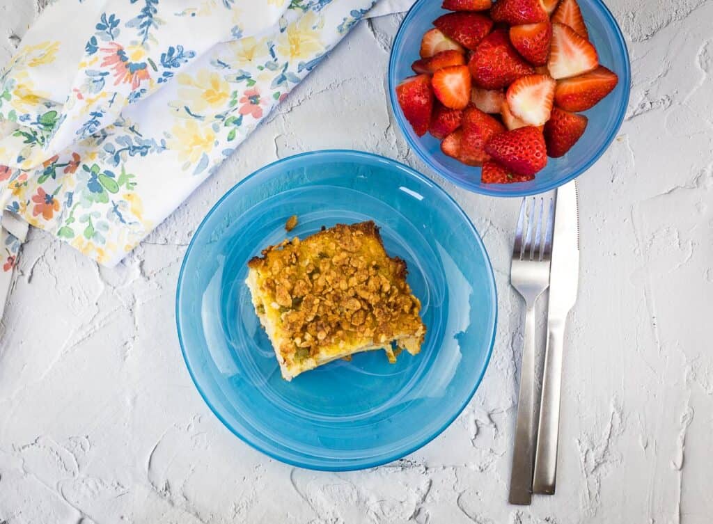 A top-down shot of christmas morning casserole on a blue plate.