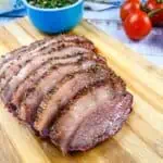 Smoked picanha sliced on a cutting board.