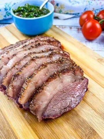 Smoked picanha sliced on a cutting board.