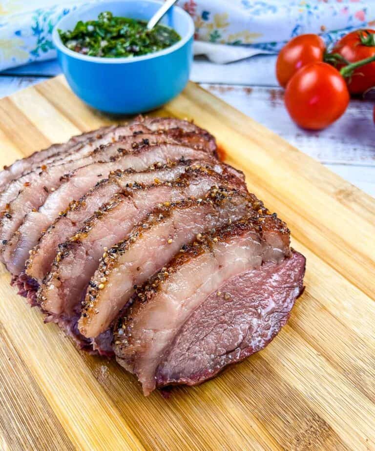 Smoked picanha sliced on a cutting board.