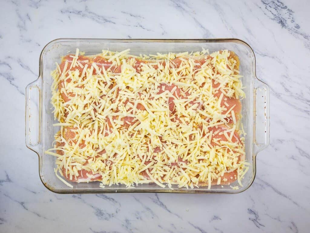 Meat and cheese added on top of the bread slices.