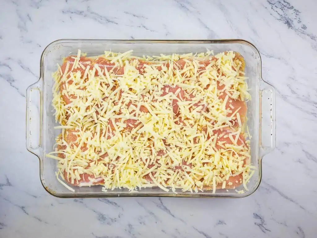 Meat and cheese added on top of the bread slices.