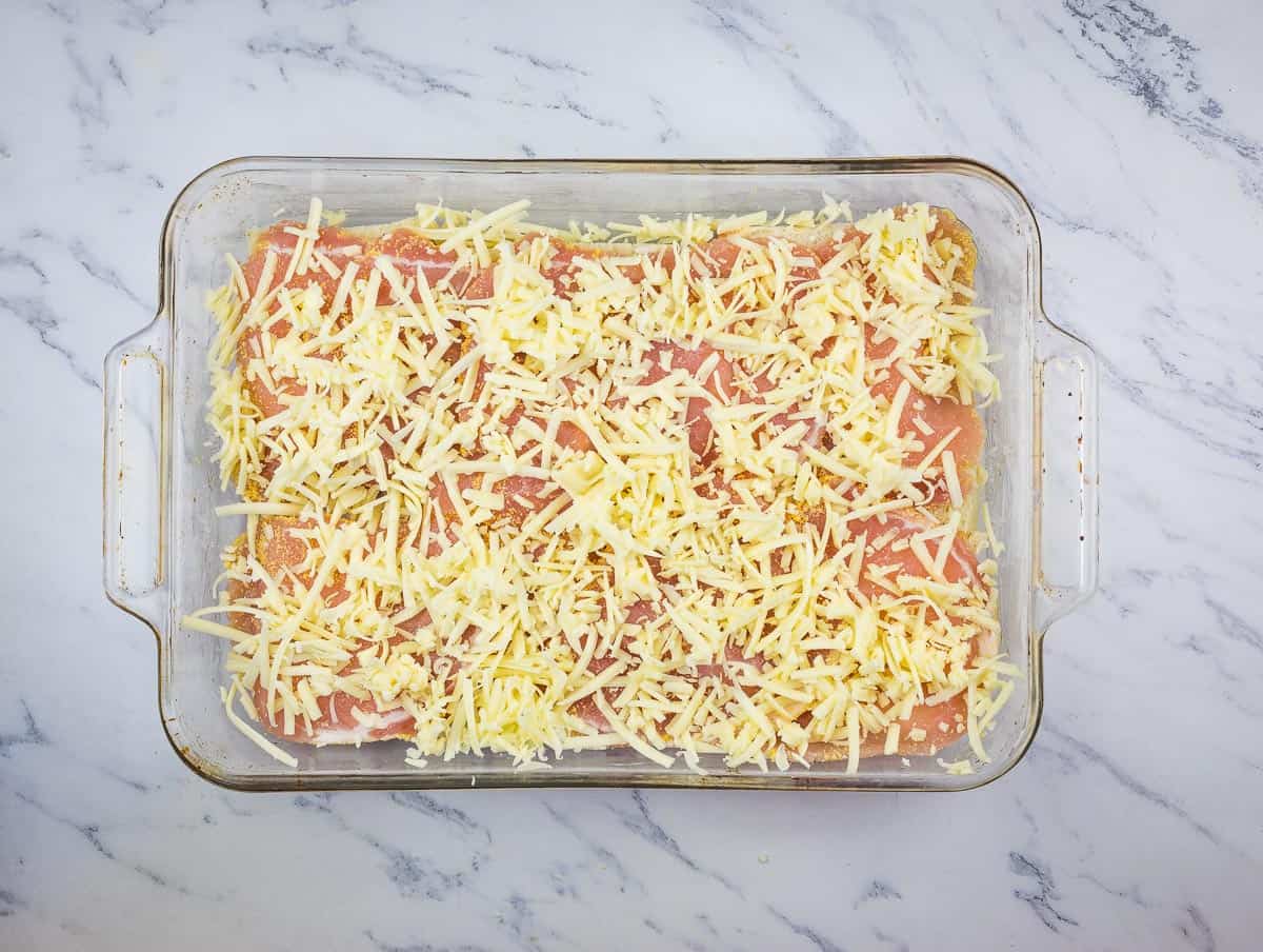 Meat and cheese added on top of the bread slices.