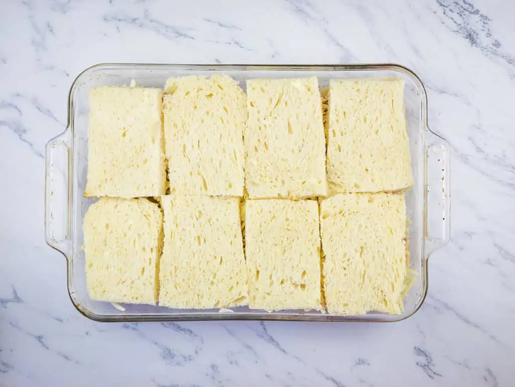 Final layer of bread on the casserole.
