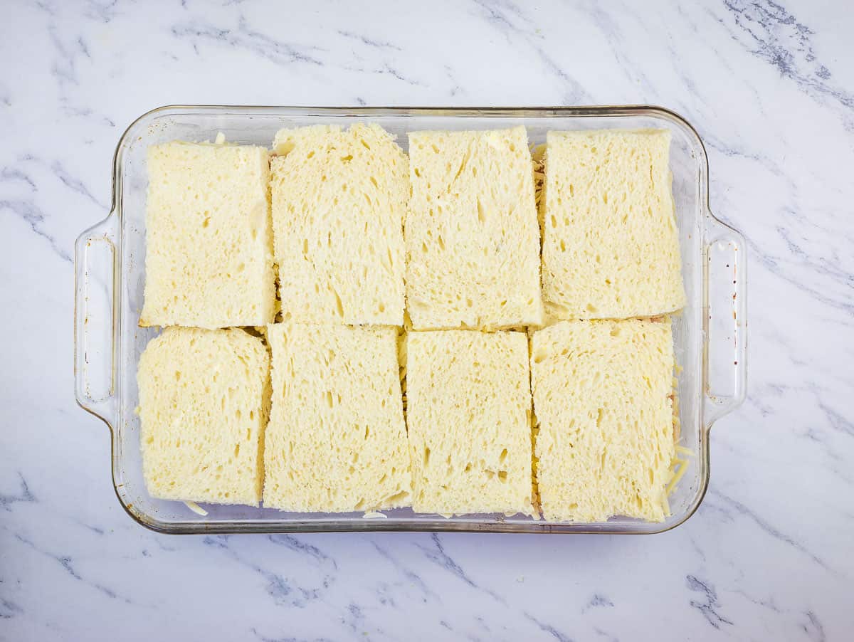 Final layer of bread on the casserole.