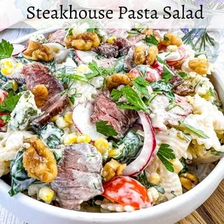 A closeup of Steakhouse Pasta Salad in a white bowl.