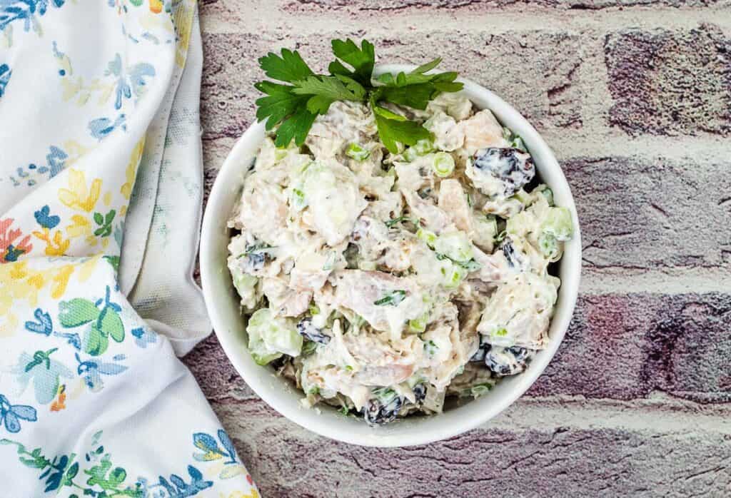 Chicken salad with cranberries and walnuts in a bowl.