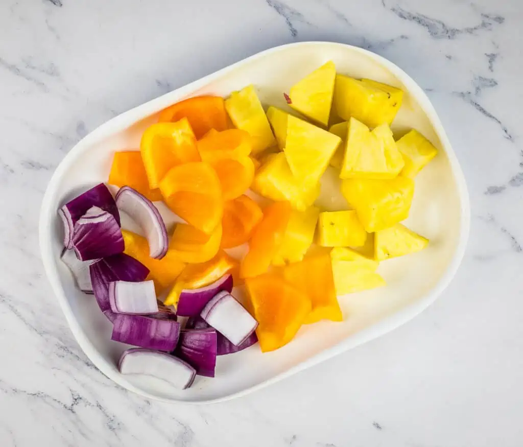 Cut fruit and veggies to make the kabobs.
