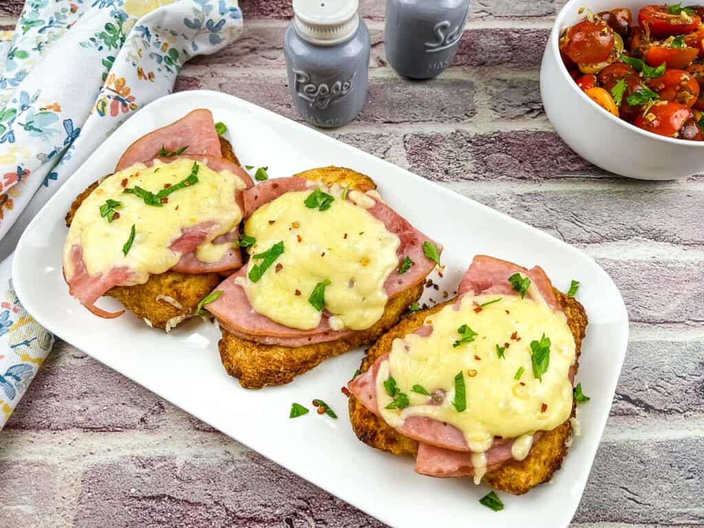 A horizontal shot of 3 chicken cordon bleu patties on a plate.