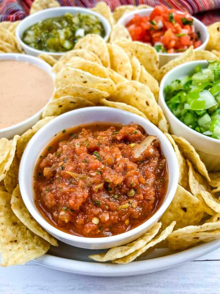 Food processor salsa on a board with other salsas and dips.