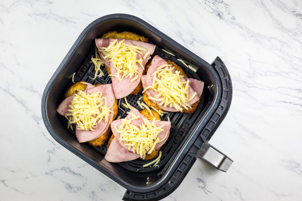 Cooked cutlets topped with ham and cheese.
