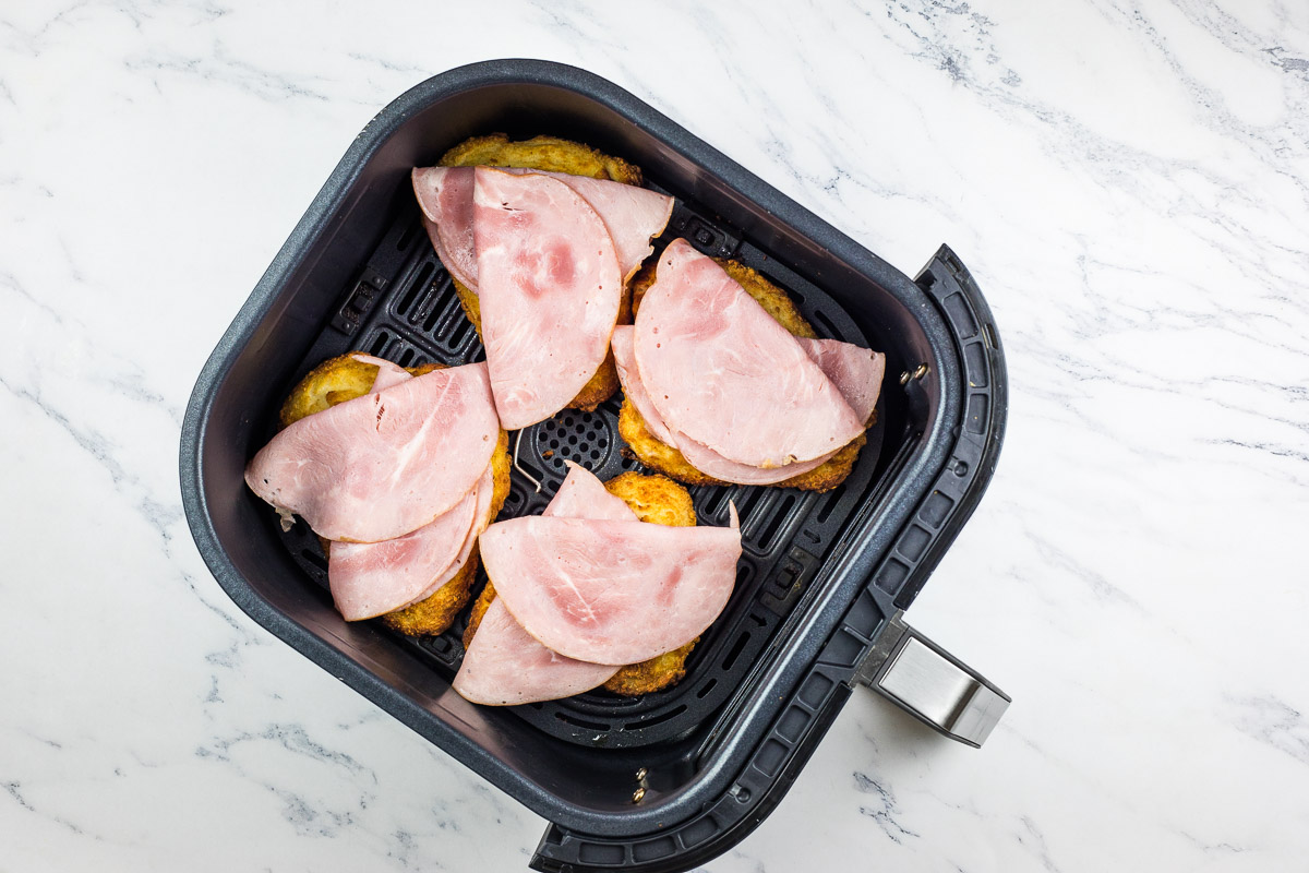 Cooked cutlets topped with ham.