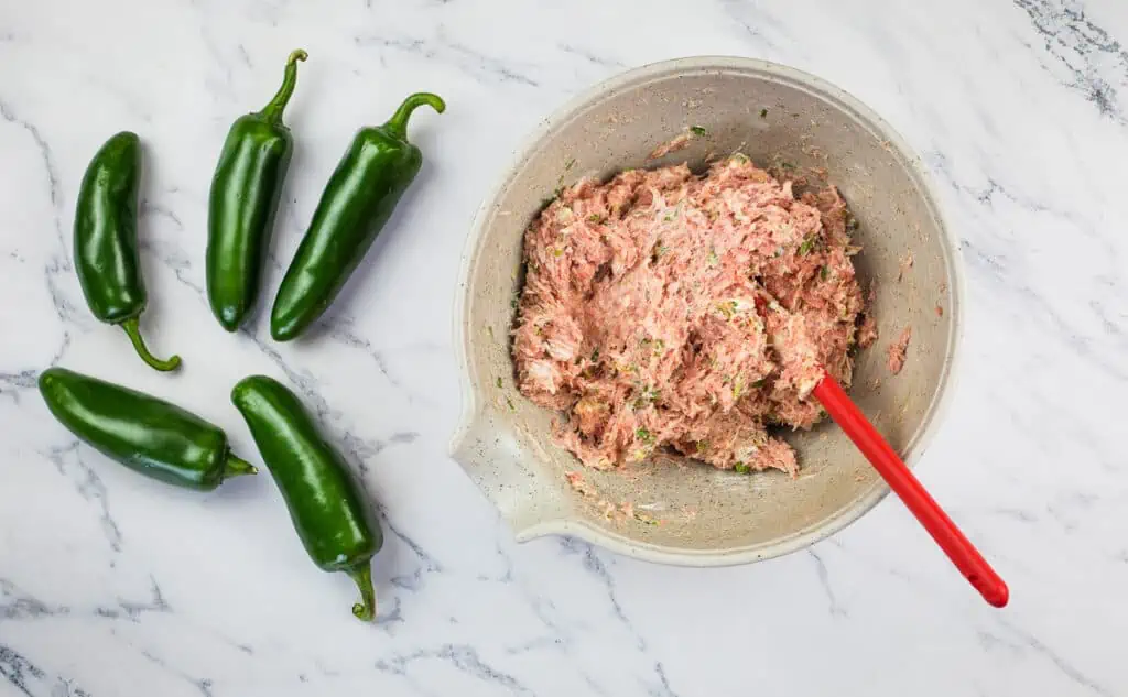Mixed pork filling in a bowl to make pork stuffed smoked jalapeno poppers.