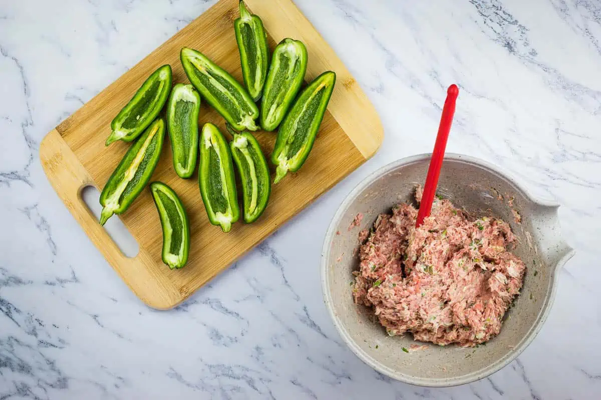 Sliced and de-seeded jalapenos next to the bowl of filling.