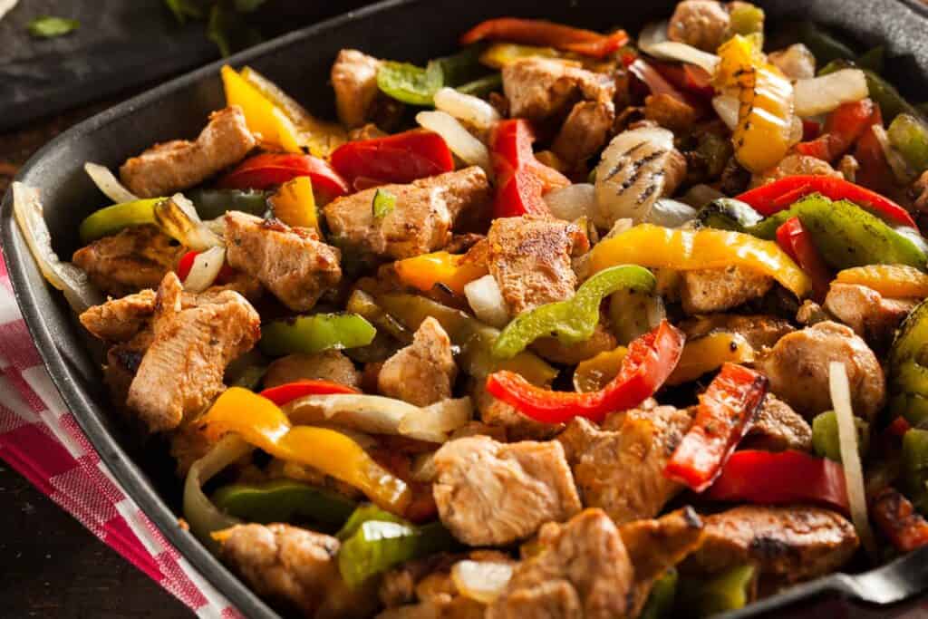 Chicken fajitas in a skillet.