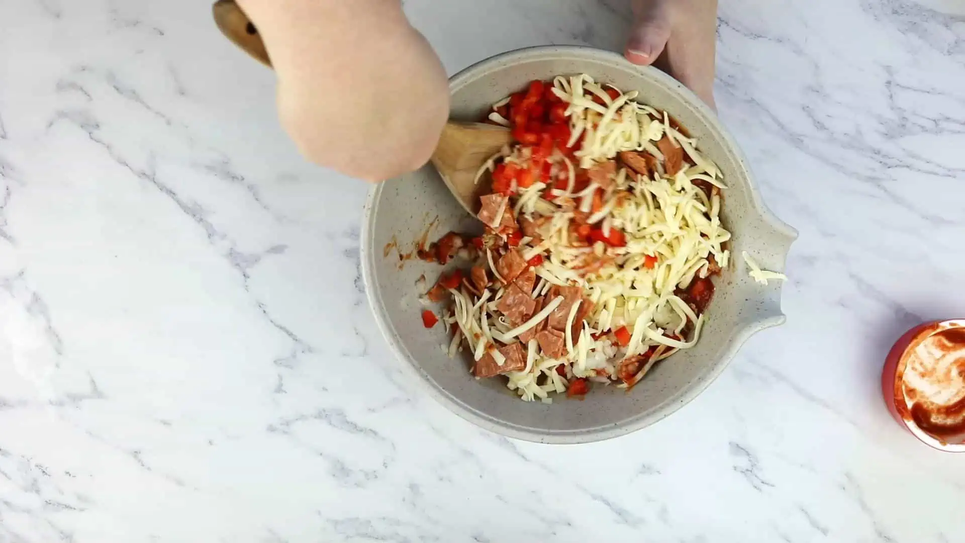 Mixing the pizza ingredients.