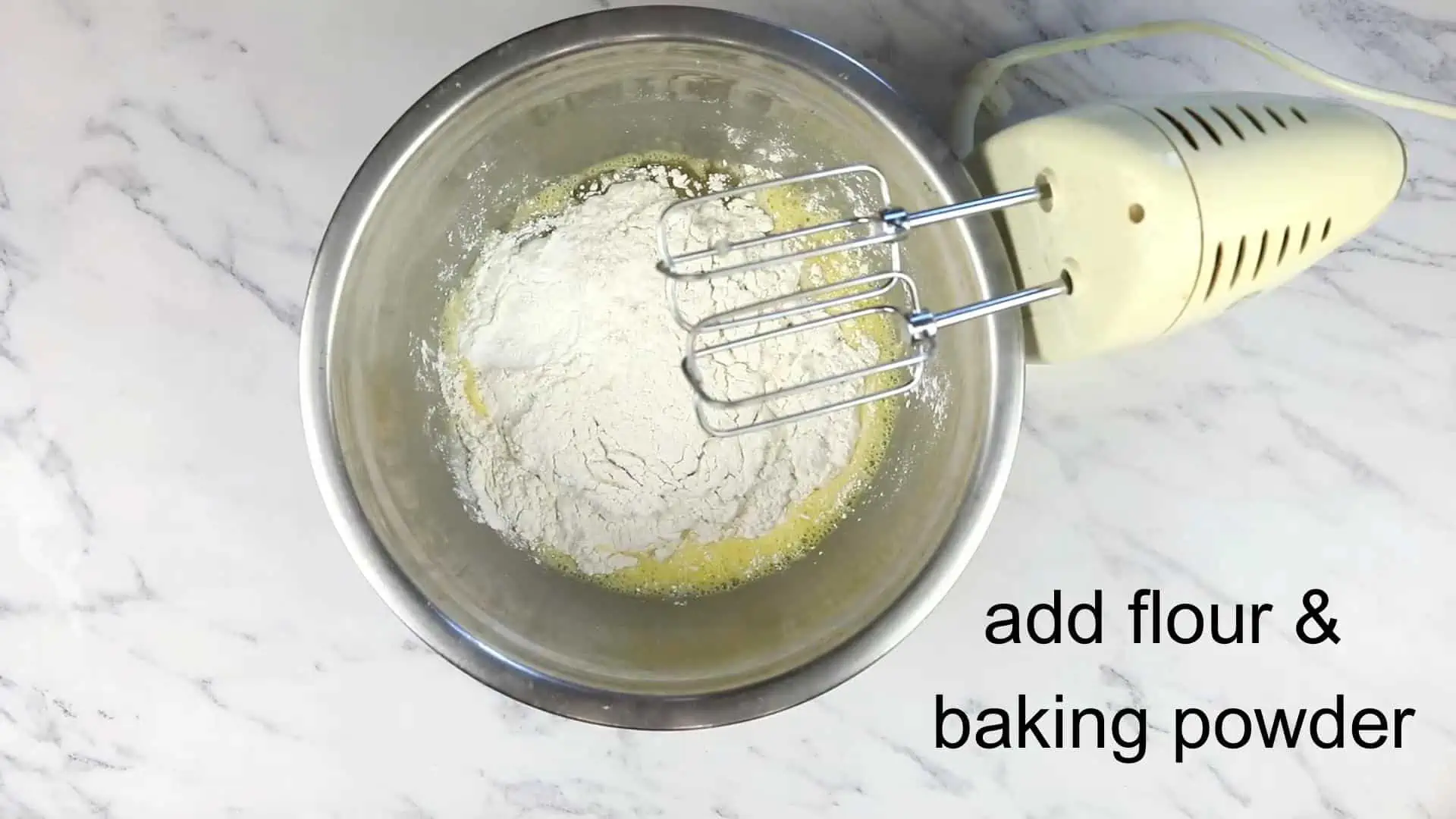 Flour and baking powder added to the eggs.