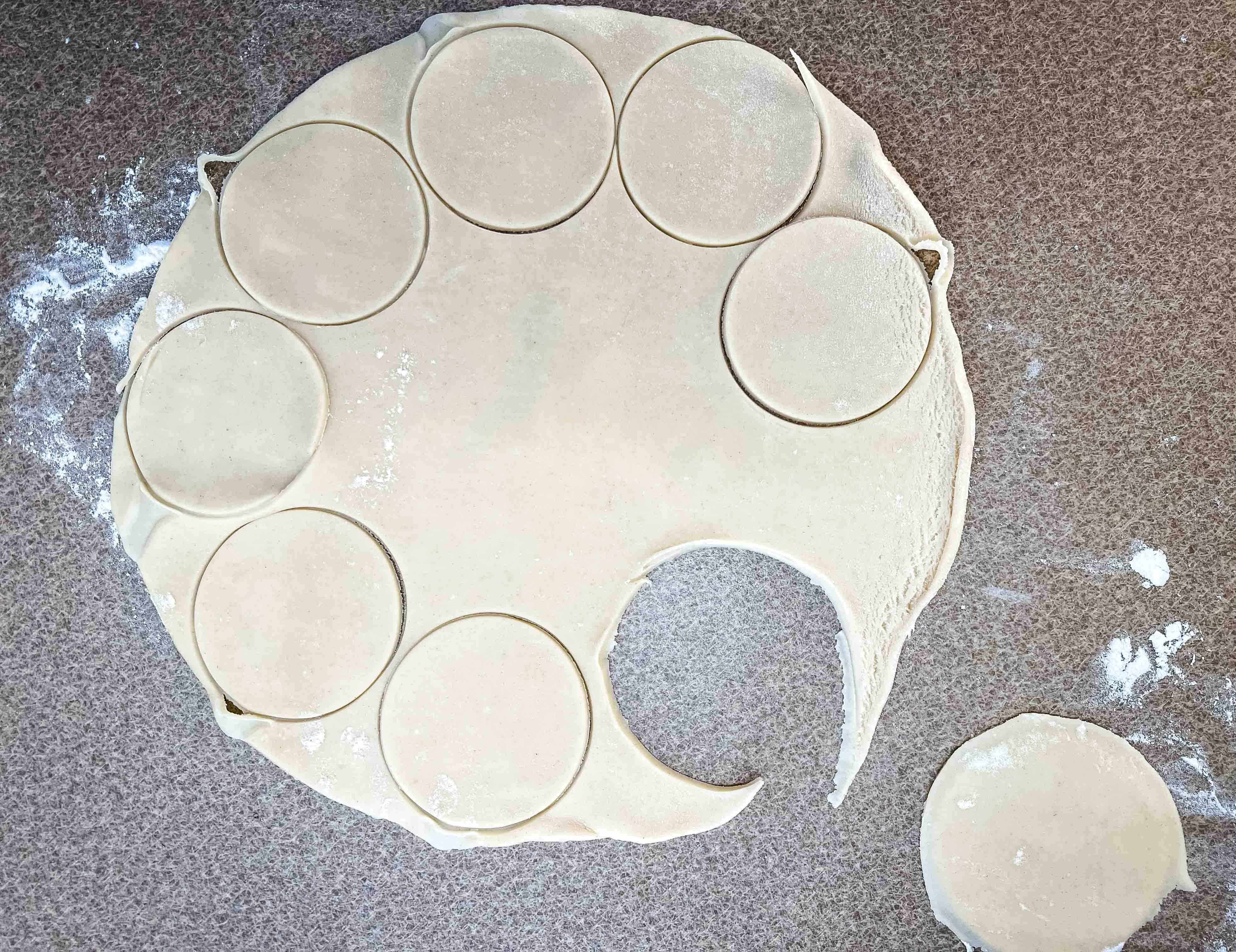 Cutting circles out of the dough.