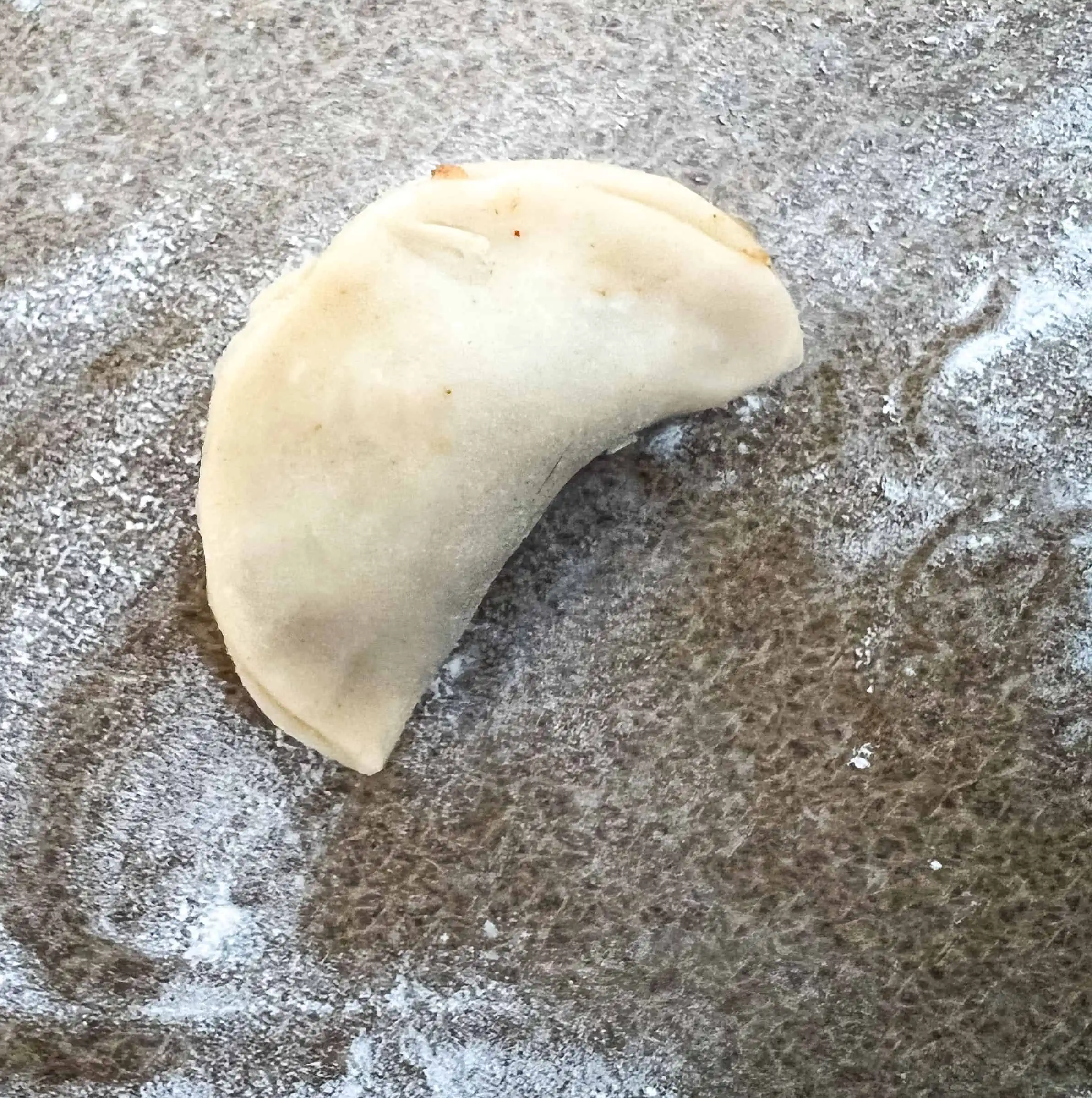 An empanada with pinched edges.