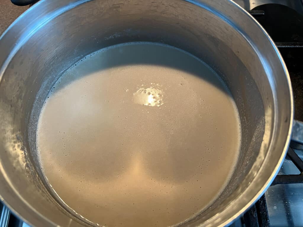 Beer and milk added to saucepan.