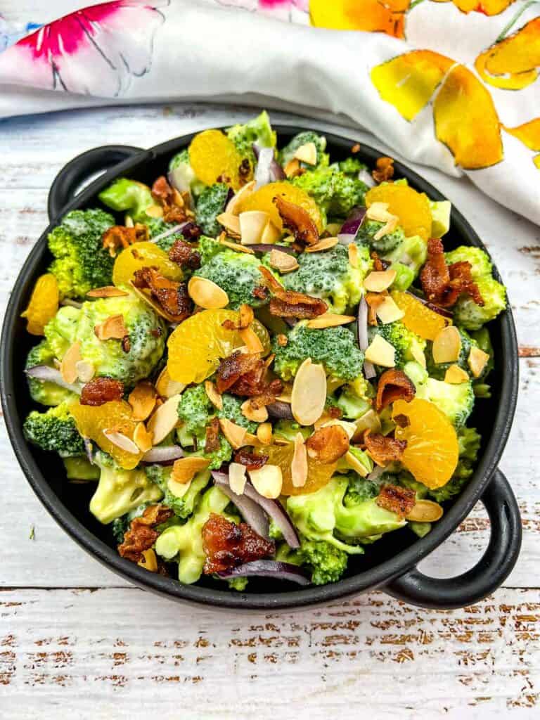 Broccoli Salad with Bacon and Almonds in a black serving dish.