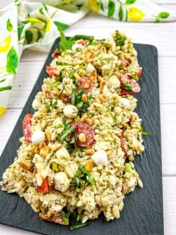 Pesto Orzo Salad on a black serving dish.