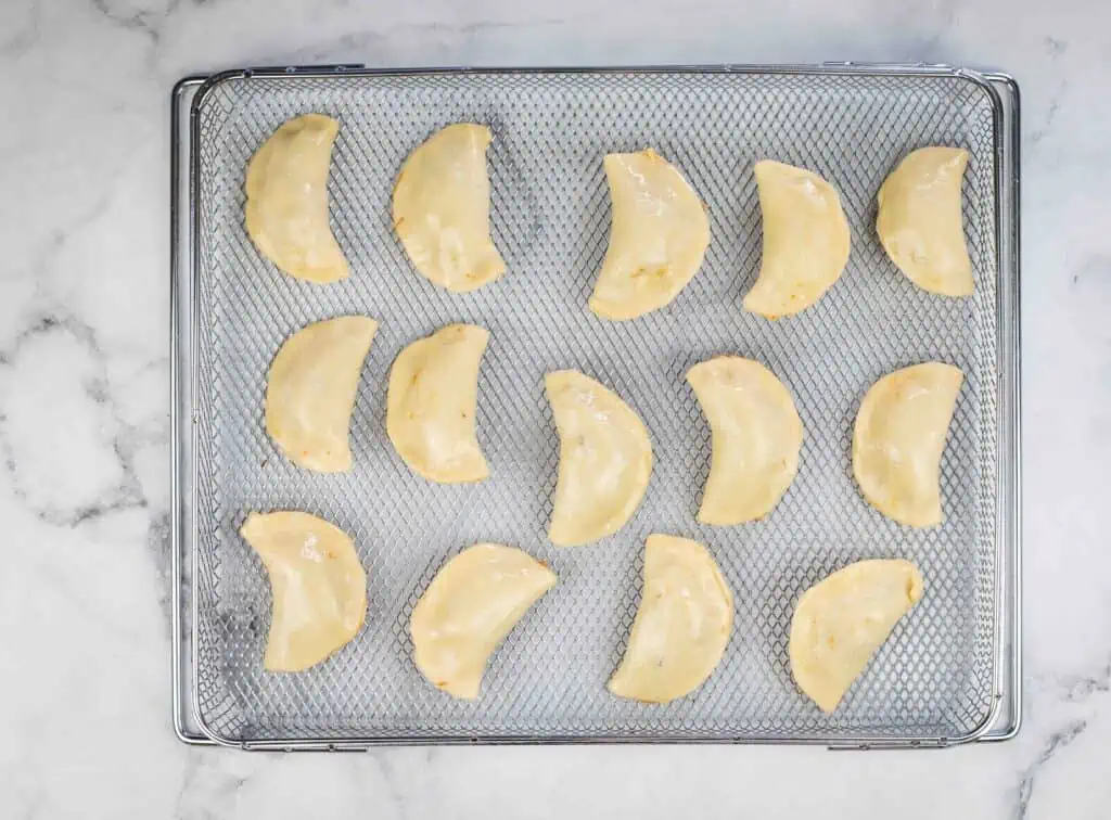 Beef empanadas on the air fryer tray.