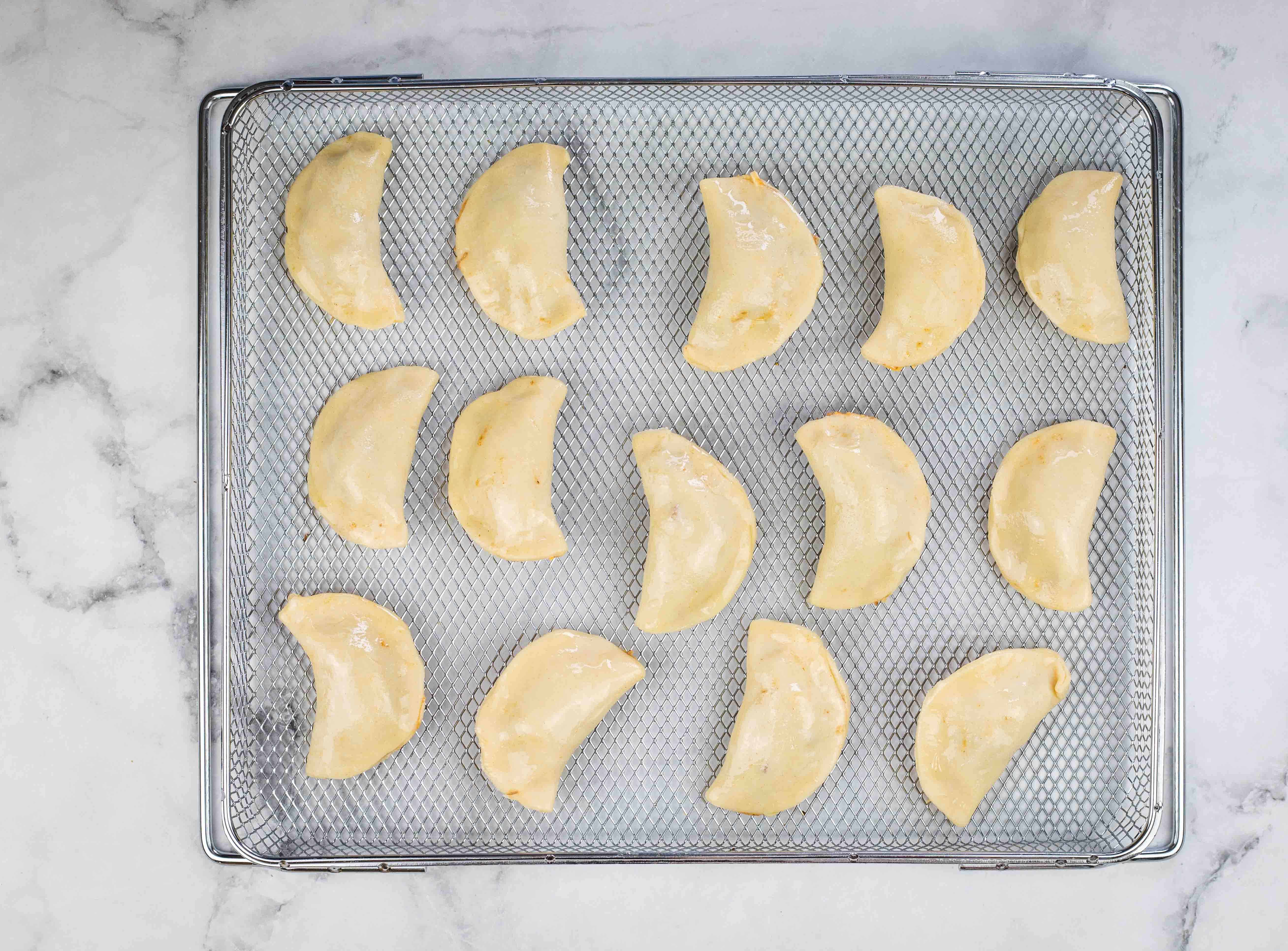 Beef empanadas on the air fryer tray.