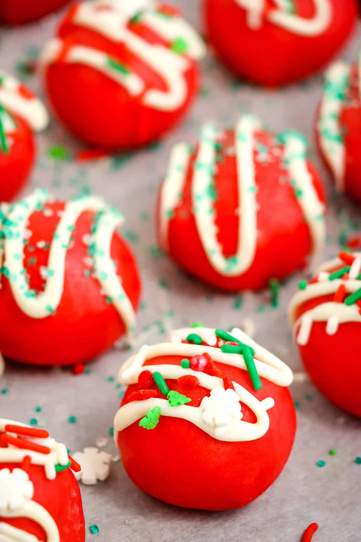 Festive red velvet truffles drizzled with white chocolate for the holidays