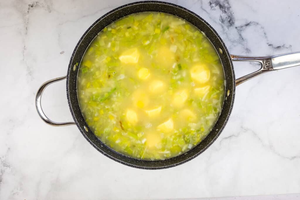Add potatoes, stock and simmer.