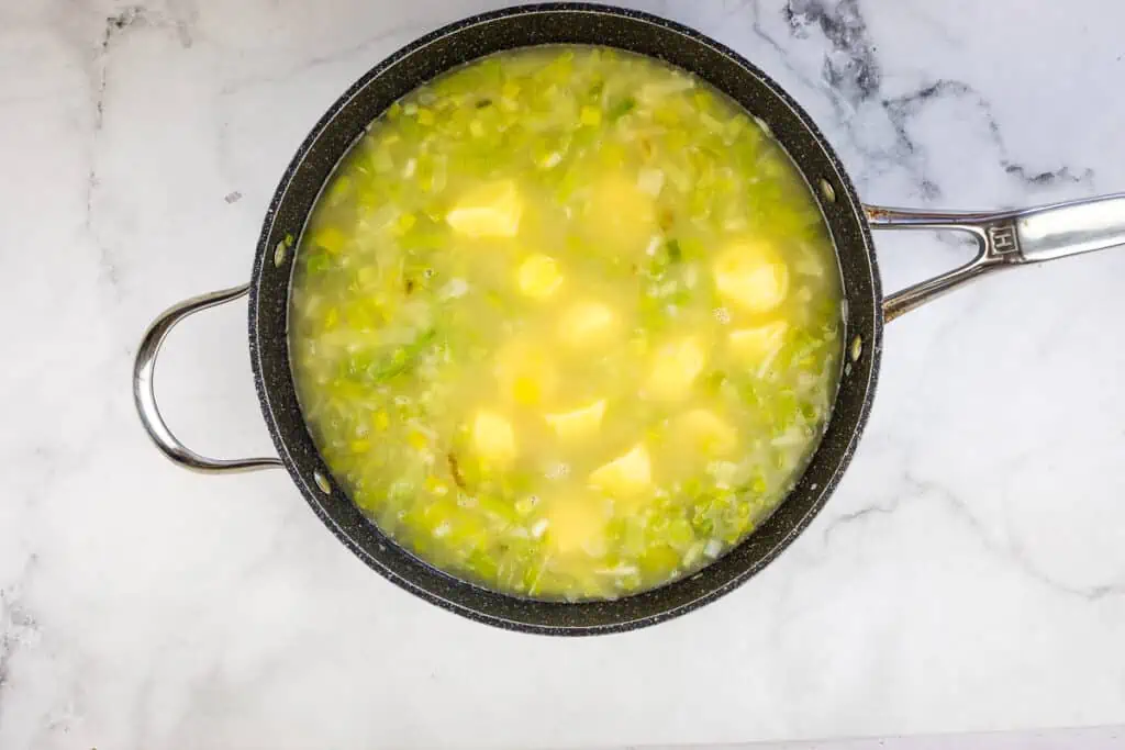 Add potatoes, stock and simmer.