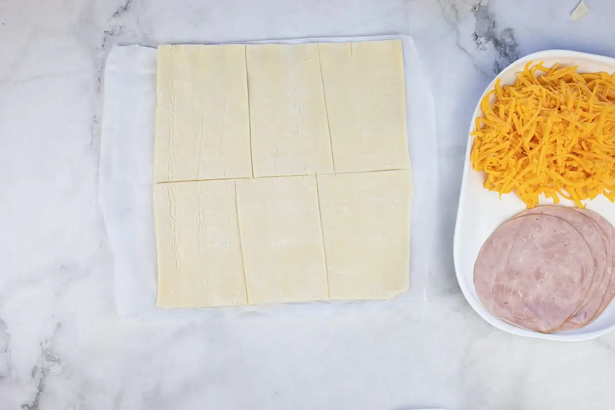 Rolled puff pastry on a counter.