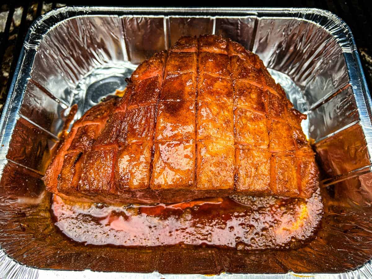 Partially cooked ham on the smoker.