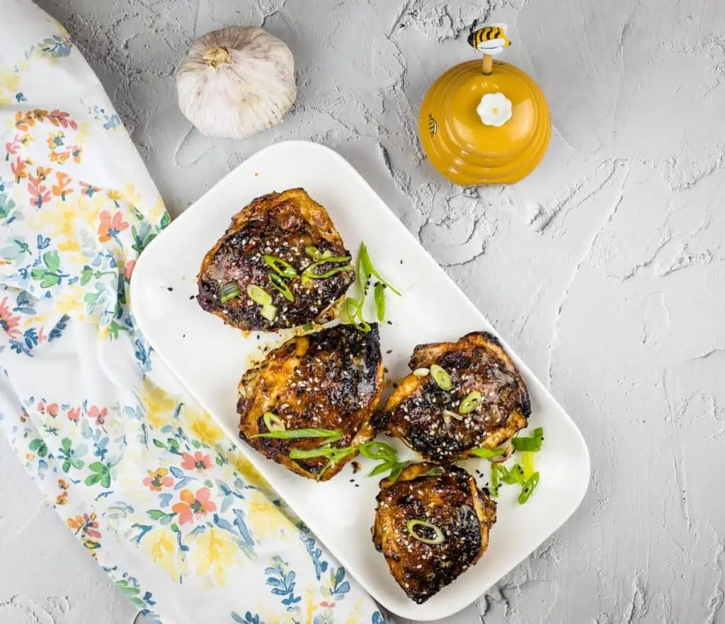 Air fryer Honey Garlic Chicken Thighs on a white plate.