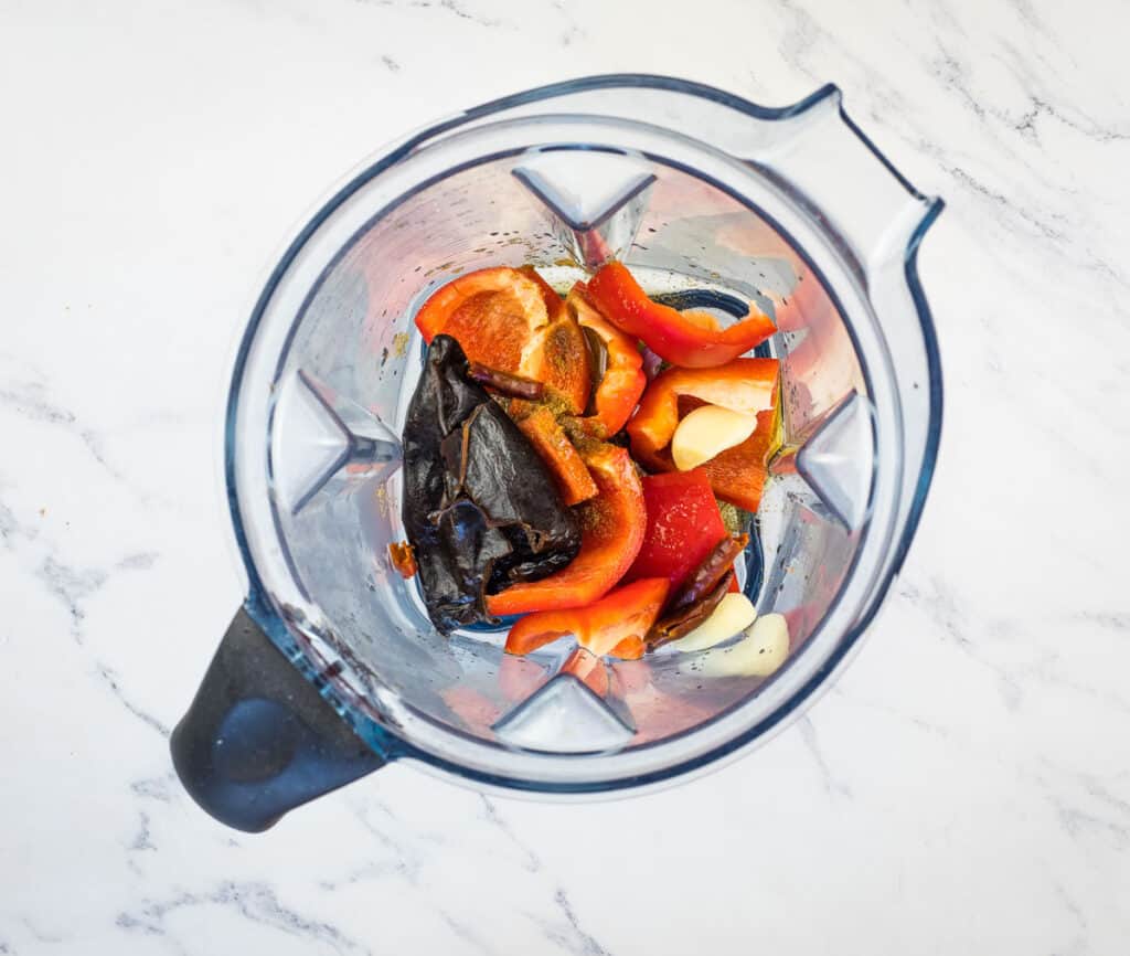 Rehydrated chilis and ingredients in a blender.