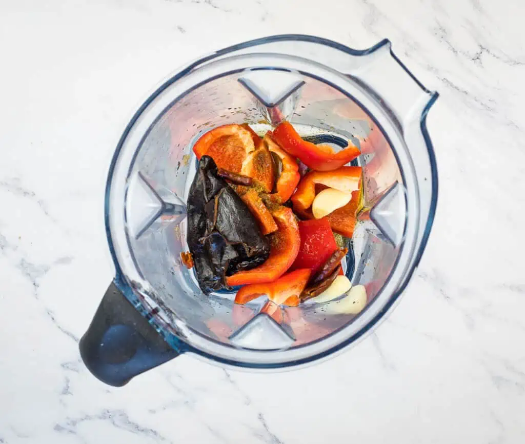 Rehydrated chilis and ingredients in a blender.