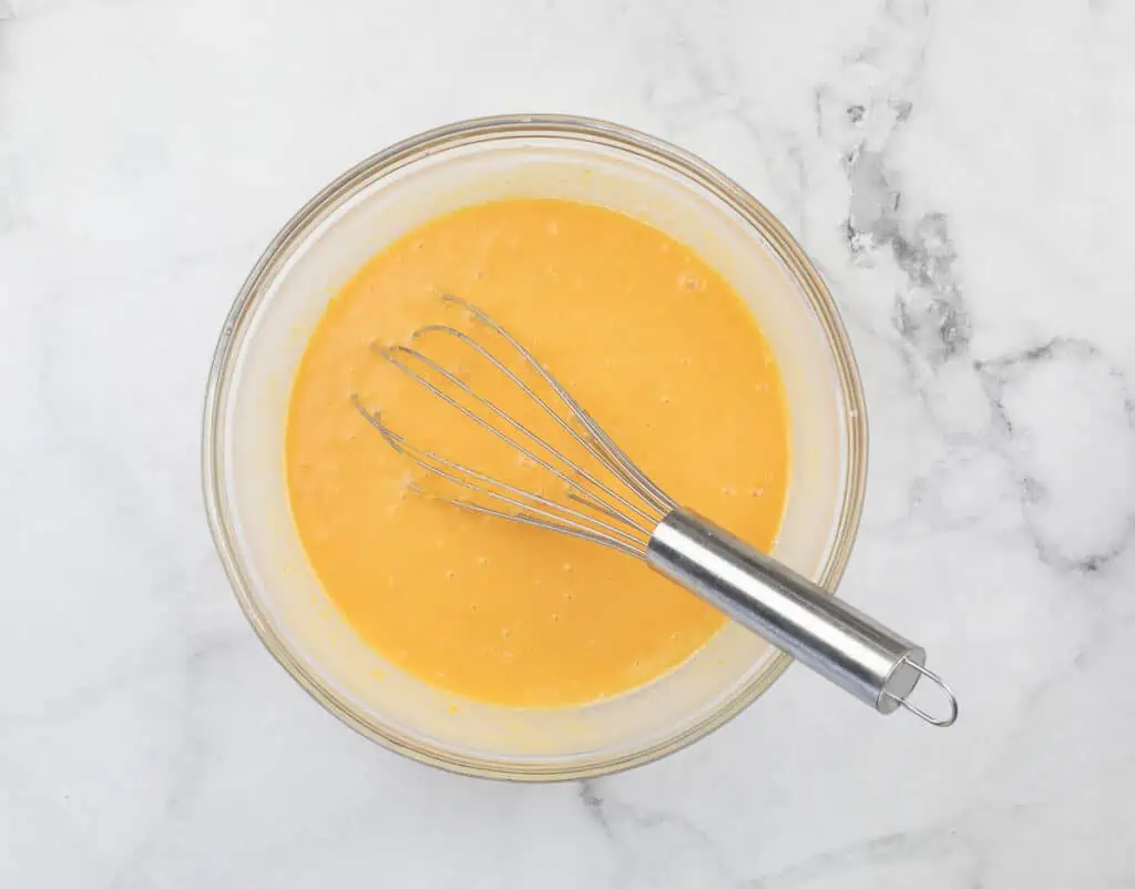 Wet ingredients whisked together in a bowl.