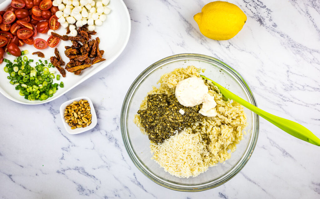Mixing the orzo with the dressing ingredients.