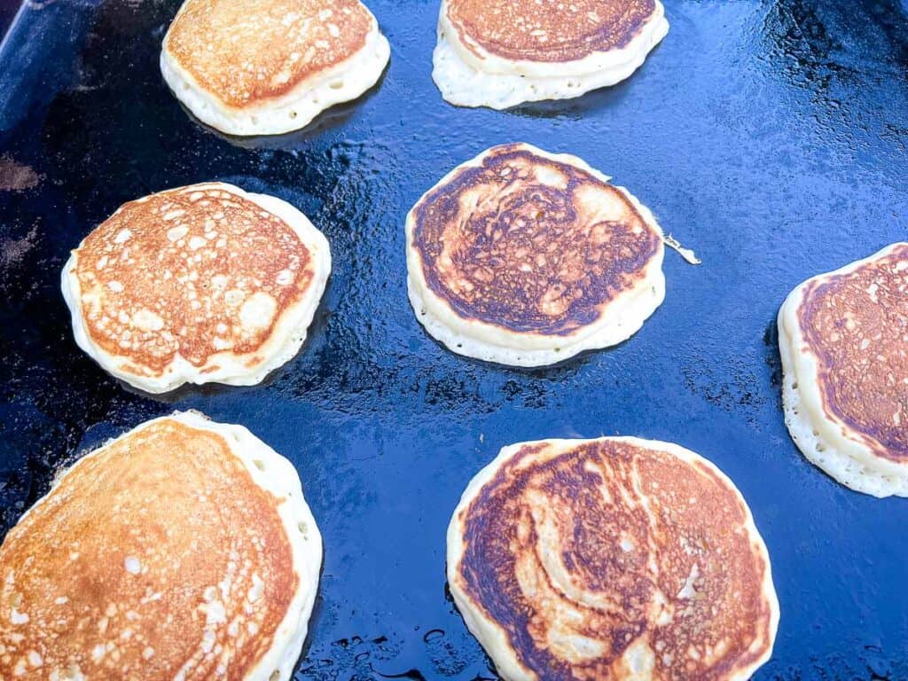 Flipped pancakes on the griddle.