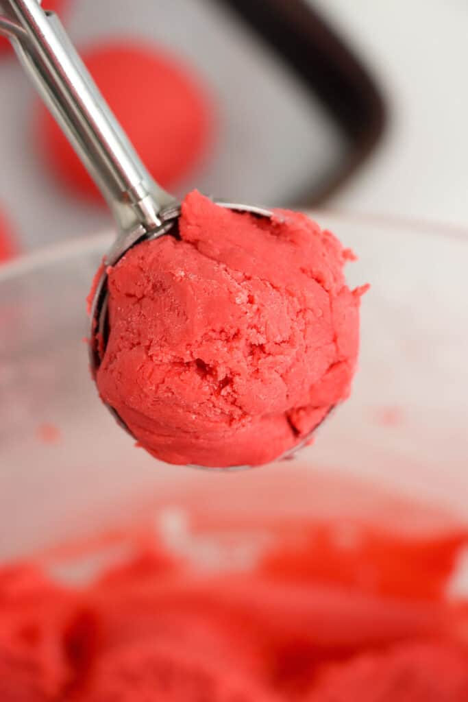 A cookie scoop filled with the truffle mixture.
