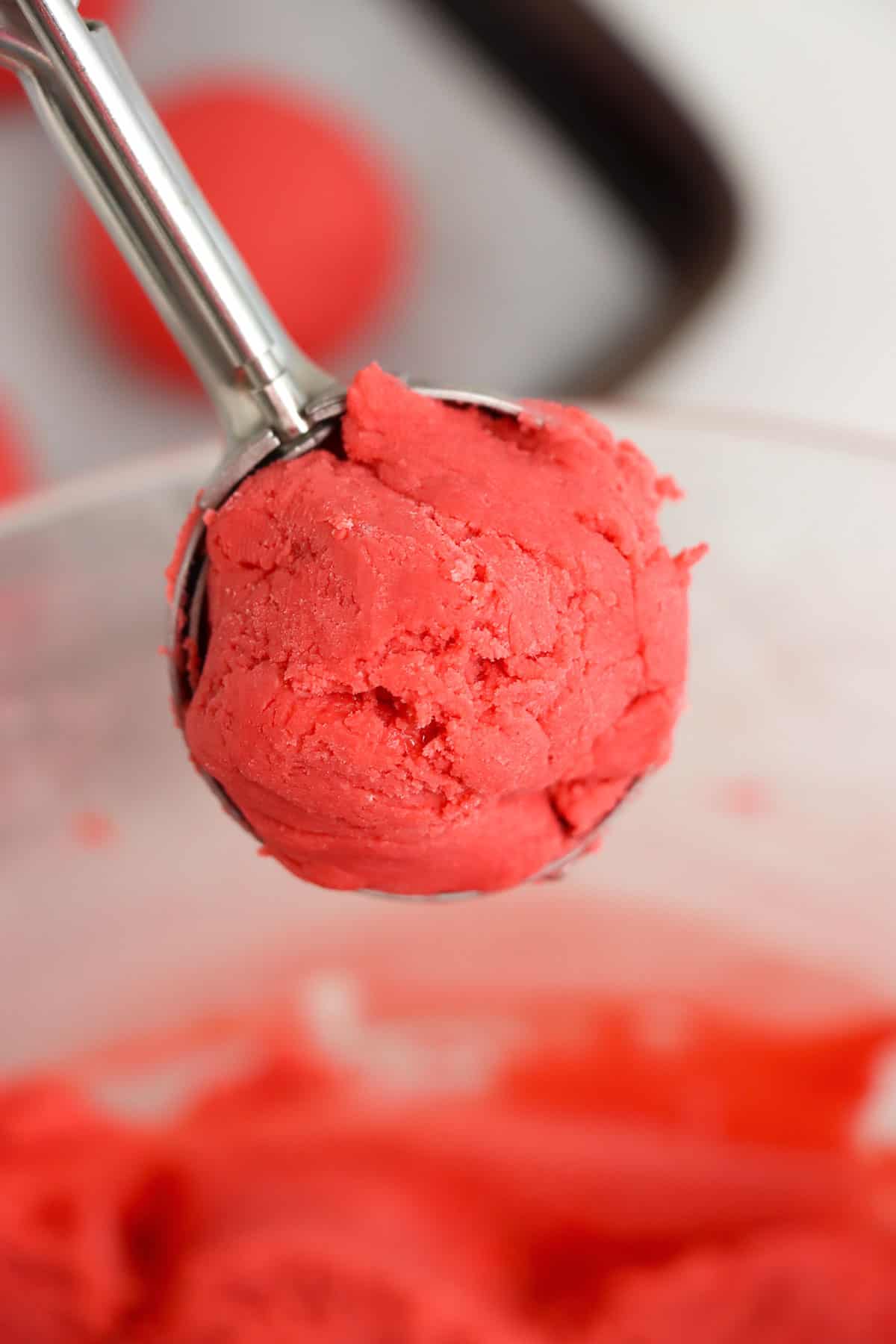 A cookie scoop filled with the truffle mixture.