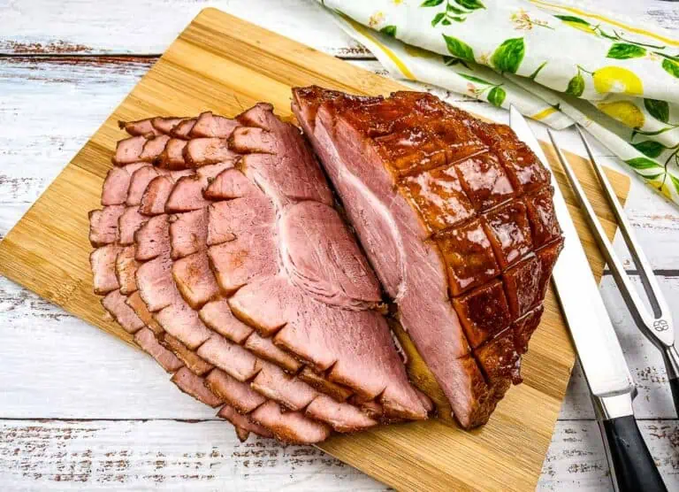 A top-down shot of a sliced Smoked Carver Ham on a cutting board.