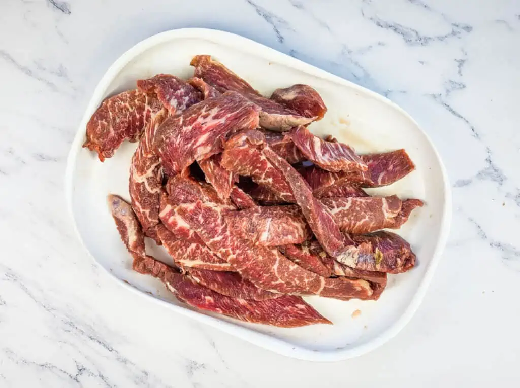Thinly slice the beef.