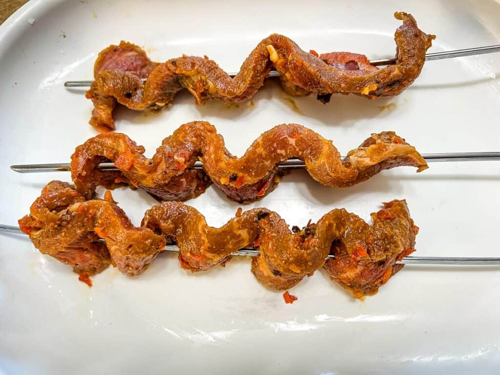 Marinated steak threaded on skewers.