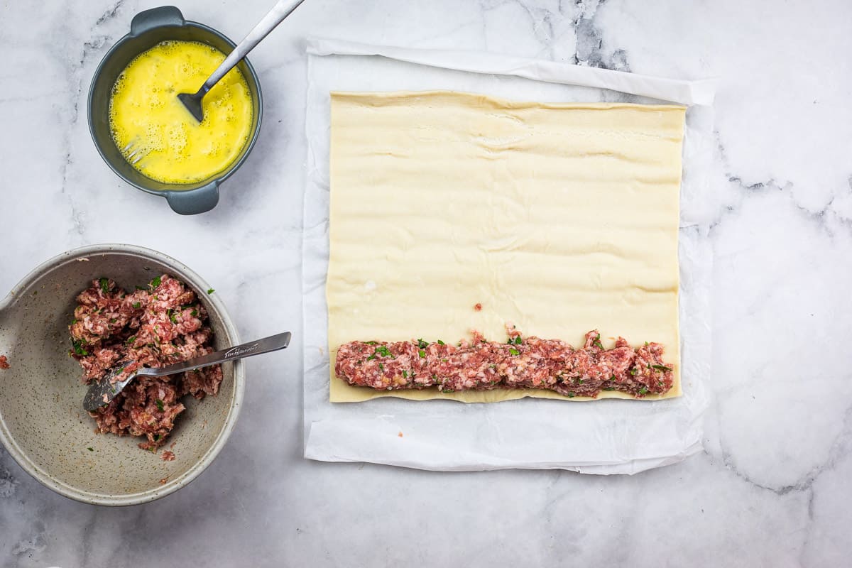 Sausage on top of the pastry sheet.