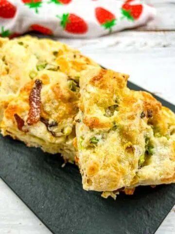 Bacon, Cheddar, Green Onion Scones on a black platter.