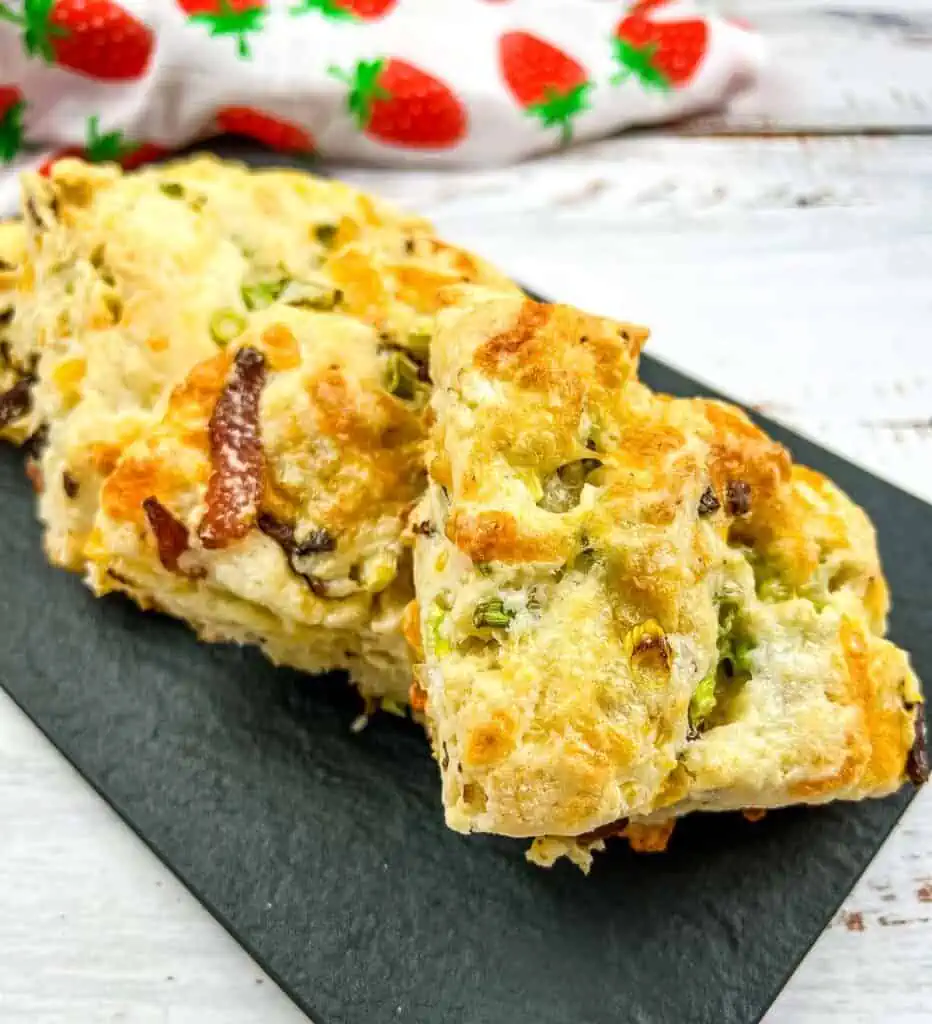 Bacon, Cheddar, Green Onion Scones on a black platter.